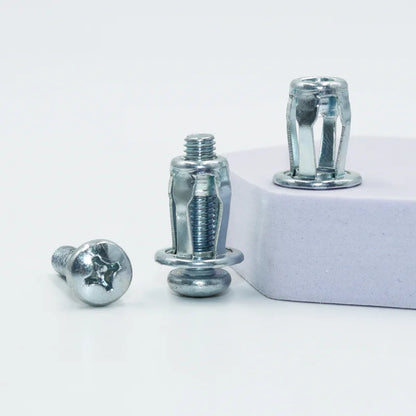 A GripNut anchor and its M4 screw beside a panel edge, with an unset anchor behind