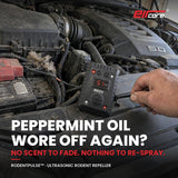 Hand zip-tying the EirCore RodentPulse ultrasonic rodent repeller to the radiator support of a pickup engine bay with signs of mice: droppings, nest material and a chewed wire